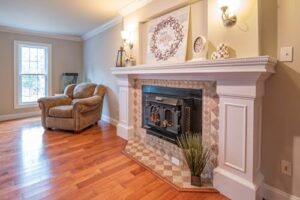 A cozy living room featuring a hardwood floor and a fireplace