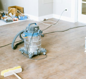 Vacuum and brush on a dirty hardwood floor