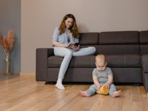 A toddler sitting on the floor with his favorite toy